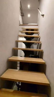 a staircase with wooden steps in a room at \u30eb\u30fc\u30c1\u30a7\u897f\u65b0\u5bbf in Tokyo