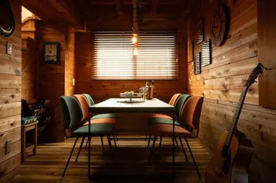 a dining room with a table and chairs and a guitar at The Archaic / Luxury apartment near Shinjuku in Tokyo