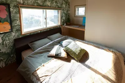 a bedroom with a bed with pillows on it at The Archaic / Luxury apartment near Shinjuku in Tokyo