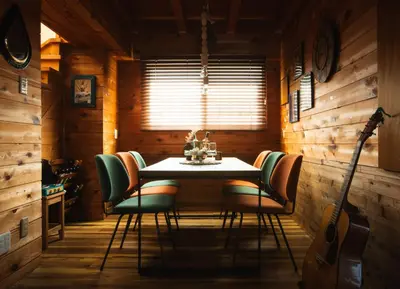 a dining room with a table and chairs and a guitar at The Archaic / Luxury apartment near Shinjuku in Tokyo