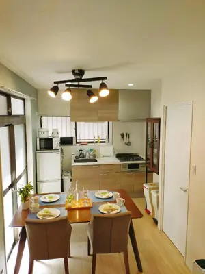 a kitchen and dining room with a table and chairs at 15min to Haneda Airport - Homies House Kamata for up to 9 guests in Tokyo