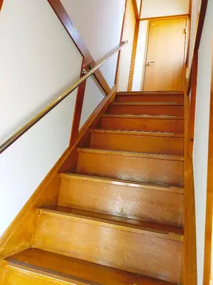 a set of stairs with a wooden door at 15min to Haneda Airport - Homies House Kamata for up to 9 guests in Tokyo
