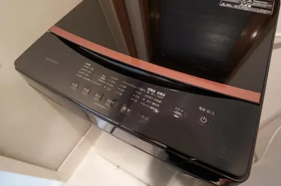 a black microwave with a red ribbon on it at FINOA Residential Suite Horikiri in Tokyo