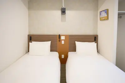 two beds sitting next to each other in a room at Nplus HOTEL Tokyo Nihonbashi in Tokyo
