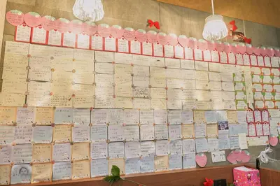 a wall filled with lots of cards on a wall at Nplus HOTEL Tokyo Nihonbashi in Tokyo