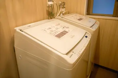 a white washing machine sitting in a room at Nplus HOTEL Tokyo Nihonbashi in Tokyo
