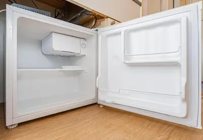 an empty refrigerator with its door open in a kitchen at \u65b0\u5bbf\u533a\u6b4c\u821e\u4f0e\u753a\u8212\u9002\u623f\u6e90\u514d\u8d39Wi-Fi#03 in Tokyo