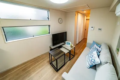 a living room with a couch and a tv at 56, Horikiri-Syobuen, Detached House for Rent, \u5800\u5207\u83d6\u84b2\u5712 in Tokyo