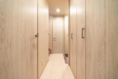 a hallway with wooden doors and a tile floor at 56, Horikiri-Syobuen, Detached House for Rent, \u5800\u5207\u83d6\u84b2\u5712 in Tokyo