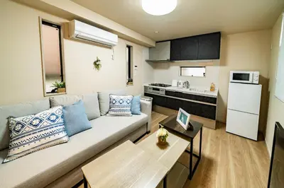 a living room with a couch and a kitchen at 56, Horikiri-Syobuen, Detached House for Rent, \u5800\u5207\u83d6\u84b2\u5712 in Tokyo