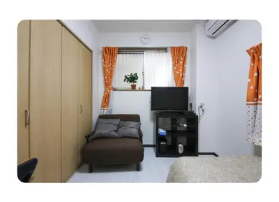 a bedroom with a couch and a tv and a bed at \u6d45\u8349\u685c\u6a4b\u30cf\u30a6\u30b9-Asakusa Sakurabashi House- in Tokyo