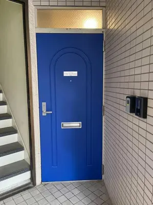 a blue door in a bathroom with a staircase at Cozy inn Oyama 101 in Tokyo