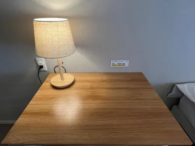 a lamp on a wooden table in a room at Cozy inn Oyama 101 in Tokyo