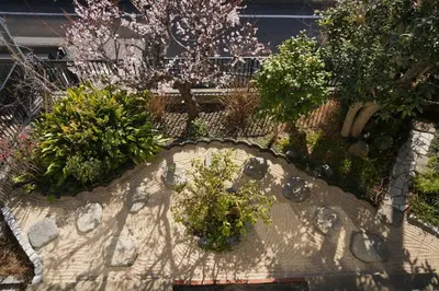 a garden with flowers and plants on a wall at Shimokitazawa Akima in Tokyo