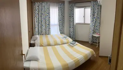 a hotel room with two beds and a window at \u6d45\u8349\u685c\u6a4b\u30cf\u30a4\u30c4 Asakusa Sakurabashi\u3000 2F in Tokyo