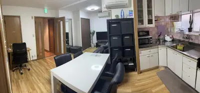 a large kitchen with a white table and chairs at \u6d45\u8349\u685c\u6a4b\u30cf\u30a4\u30c4 Asakusa Sakurabashi\u3000 2F in Tokyo