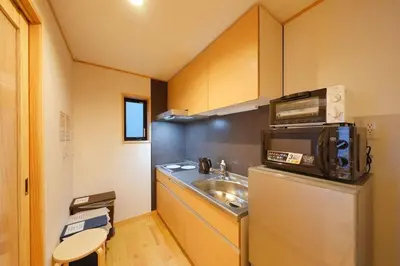 a small kitchen with a sink and a microwave at Yadoya Hototogisu - Vacation STAY 37432v in Tokyo