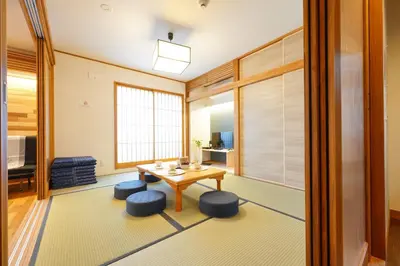 a living room with a table and two stools at Yadoya Hototogisu - Vacation STAY 37432v in Tokyo