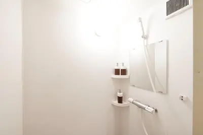 a white bathroom with a mirror and a sink at Yadoya Hototogisu - Vacation STAY 37442v in Tokyo