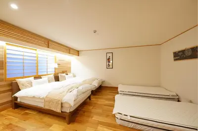 a bedroom with three beds and a window at Yadoya Hototogisu - Vacation STAY 37442v in Tokyo