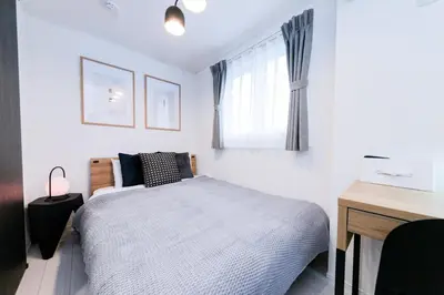 a bedroom with a bed and a desk and a window at HOTEL Dining Plus - Vacation STAY 39103v in Tokyo