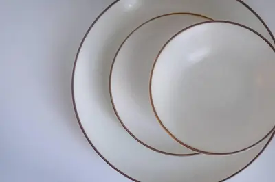 a white plate with a brown stripe on it at unito residence HIGASHISHINJUKU in Tokyo
