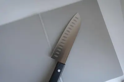 a knife sitting on top of a cutting board at unito residence HIGASHISHINJUKU in Tokyo