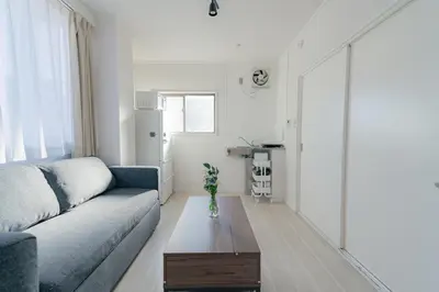 a living room with a couch and a coffee table at unito residence WASEDA in Tokyo