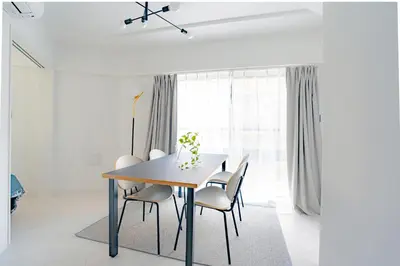 a dining room with a table and chairs at unito residence OTSUKA in Tokyo