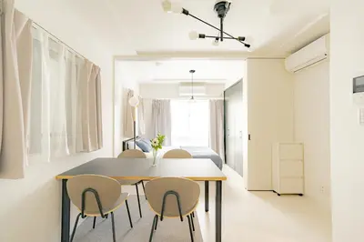 a dining room with a table and chairs at unito residence OTSUKA in Tokyo