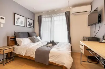 a bedroom with a bed and a window at Felice Nishi-Shinjuku in Tokyo