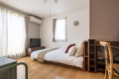 a bedroom with a bed and a television in it at Felice Nishi-Shinjuku in Tokyo