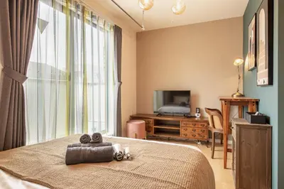 a bedroom with a bed with a teddy bear on it at Felice Nishi-Shinjuku in Tokyo