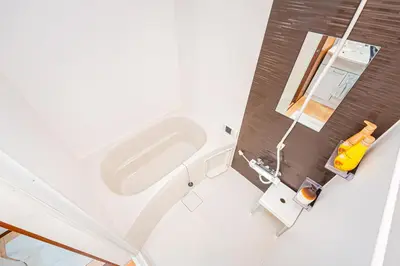 a bathroom with a white bath tub in a room at Himawari in Tokyo