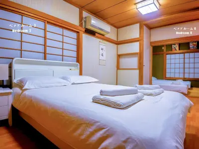 a bedroom with a large white bed with towels on it at 7\u6642IN19\u6642OUT # \u6c60\u888b\u738b\u5b50\u8d64\u7fbd\u99c5\u7121\u6599\u9001\u8fce # \u4e0a\u91ce\u99c514\u5206 # \u4e00\u68df\u8cb8\u3057 # 2LDK2LDK # \u6700\u592724\u4eba # 7 00 IN19 00 OUT # Free pick-up at Ikebukuro, Oji, and Akabane Stations # 14 min to Ueno # Whole house rental # 2LDK2LDK # Max 24 in Tokyo