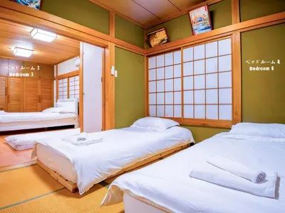 two beds in a room with two windows at 7\u6642IN19\u6642OUT # \u6c60\u888b\u738b\u5b50\u8d64\u7fbd\u99c5\u7121\u6599\u9001\u8fce # \u4e0a\u91ce\u99c514\u5206 # \u4e00\u68df\u8cb8\u3057 # 2LDK2LDK # \u6700\u592724\u4eba # 7 00 IN19 00 OUT # Free pick-up at Ikebukuro, Oji, and Akabane Stations # 14 min to Ueno # Whole house rental # 2LDK2LDK # Max 24 in Tokyo