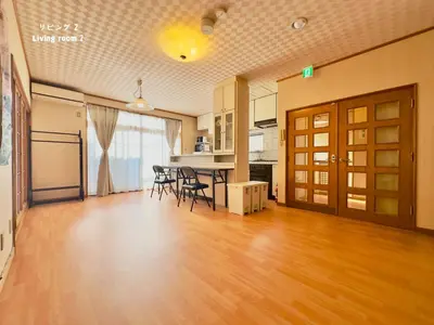 an empty living room with a table and chairs at 7\u6642IN19\u6642OUT # \u6c60\u888b\u738b\u5b50\u8d64\u7fbd\u99c5\u7121\u6599\u9001\u8fce # \u4e0a\u91ce\u99c514\u5206 # \u4e00\u68df\u8cb8\u3057 # 2LDK2LDK # \u6700\u592724\u4eba # 7 00 IN19 00 OUT # Free pick-up at Ikebukuro, Oji, and Akabane Stations # 14 min to Ueno # Whole house rental # 2LDK2LDK # Max 24 in Tokyo