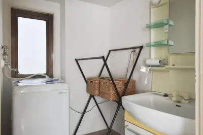 a laundry room with a sink and a washing machine at \u30d7\u30ea\u30cd\u30c3\u30c4\u65b0\u5bbf\u30d3\u30eb3\u968e in Tokyo