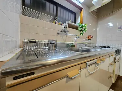 a kitchen with a stainless steel counter top and a sink at AsahiStay -Koiwa, Free parking O, Whole Family House, Japanese garden taste in Tokyo