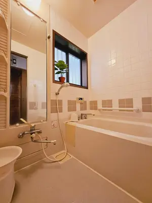 a bathroom with a tub and a toilet and a sink at AsahiStay -Koiwa, Free parking O, Whole Family House, Japanese garden taste in Tokyo