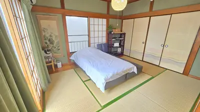 a bedroom with a bed and a large window at AsahiStay -Koiwa, Free parking O, Whole Family House, Japanese garden taste in Tokyo
