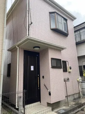 a brick house with a black door and a window at AsahiStay -Koiwa, Free parking O, Whole Family House, Japanese garden taste in Tokyo