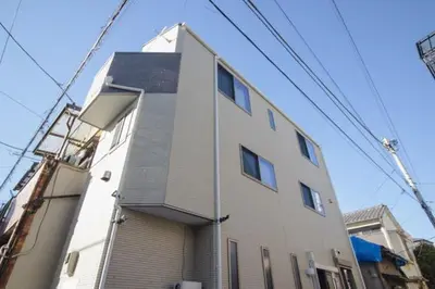 a tall white building with a lot of windows at QiQi House serenity - Vacation STAY 43379v in Tokyo