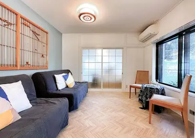 a living room with a couch and a chair at The Bonsai Otsuka 202, Fresh Parkside Private Apartment in Central Tokyo in Tokyo