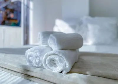 a pile of towels sitting on top of a bed at The Bonsai Otsuka 202, Fresh Parkside Private Apartment in Central Tokyo in Tokyo