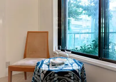 a table with two glasses and a chair and a window at The Bonsai Otsuka 202, Fresh Parkside Private Apartment in Central Tokyo in Tokyo