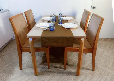 a wooden table with plates and wine glasses on it at The Bonsai Otsuka 202, Fresh Parkside Private Apartment in Central Tokyo in Tokyo