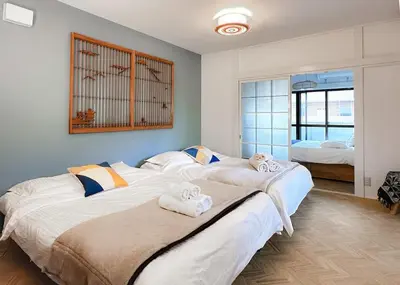 a bedroom with two beds with towels on them at The Bonsai Otsuka 202, Fresh Parkside Private Apartment in Central Tokyo in Tokyo