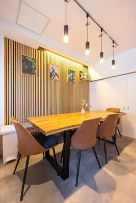 a dining room with a wooden table and chairs at Eden House Skytree & Skygarden in Tokyo