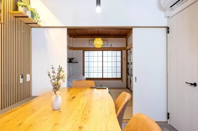 a dining room with a wooden table and chairs at Eden House Skytree & Skygarden in Tokyo